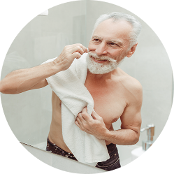 Older man drying his hair and beard with a towel